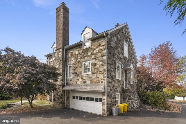 view of side of home with a garage