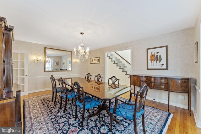 dining area with an inviting chandelier and light wood-type flooring