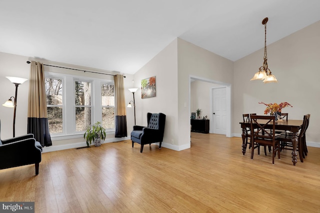 living area with high vaulted ceiling and light wood-type flooring