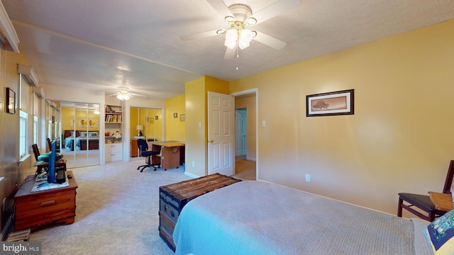 bedroom featuring ceiling fan and light carpet