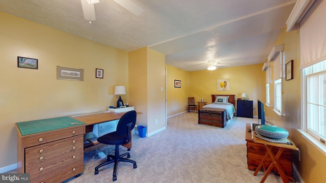 carpeted bedroom with a textured ceiling and ceiling fan