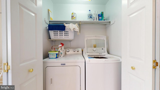 washroom with washing machine and clothes dryer