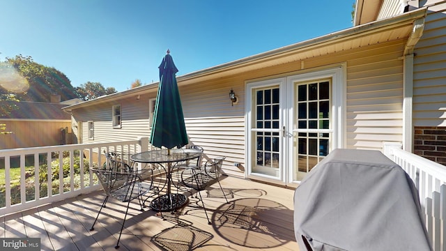 wooden deck featuring area for grilling and french doors