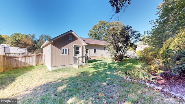 rear view of property with a lawn