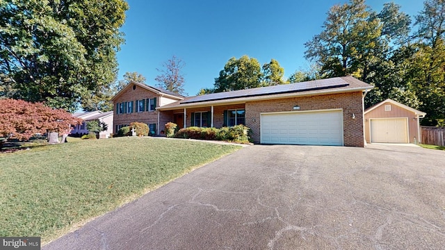 view of front of house with a front yard and solar panels