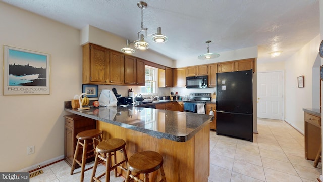 kitchen featuring kitchen peninsula, black appliances, sink, and hanging light fixtures