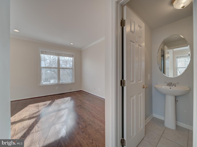 bathroom featuring ornamental molding and wood-type flooring