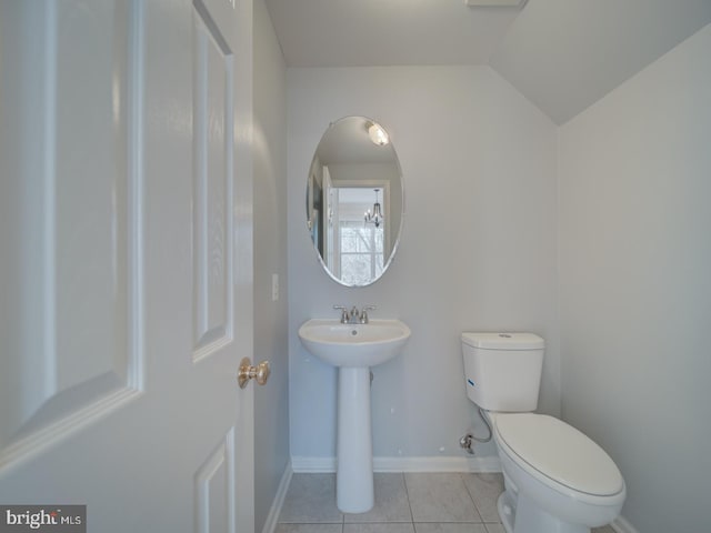 bathroom featuring tile patterned flooring, vaulted ceiling, and toilet