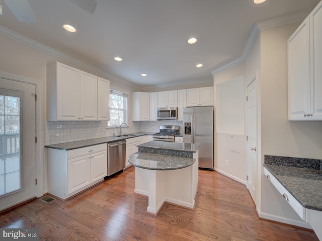 kitchen with stainless steel appliances, white cabinets, and a kitchen island