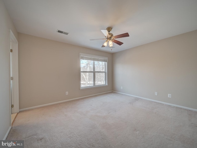 carpeted spare room with ceiling fan