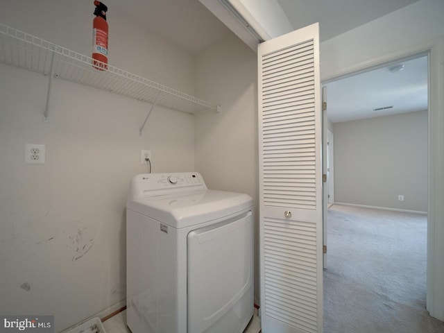 clothes washing area featuring washer / dryer and light carpet