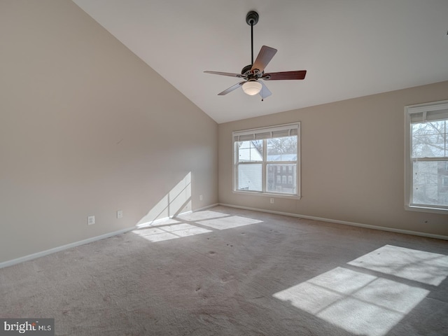 carpeted empty room featuring plenty of natural light, high vaulted ceiling, and ceiling fan