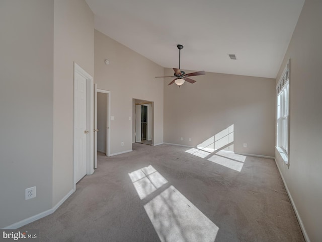 unfurnished living room with ceiling fan, light colored carpet, and high vaulted ceiling