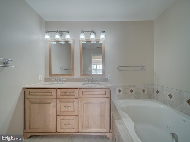 bathroom with tile patterned floors, tiled bath, and vanity