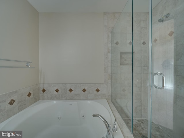 bathroom featuring shower with separate bathtub