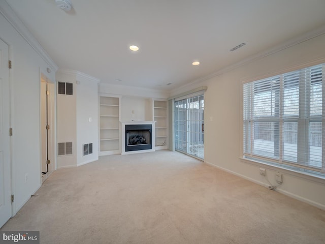 unfurnished living room featuring ornamental molding and light carpet