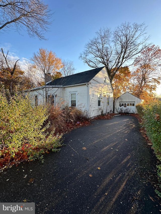 view of home's exterior featuring a garage and an outdoor structure