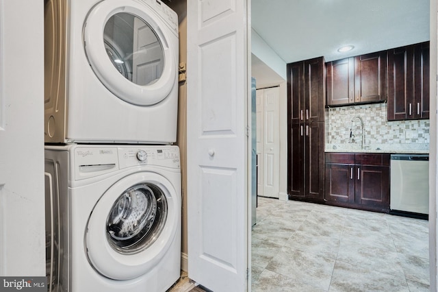 washroom featuring sink and stacked washer / drying machine