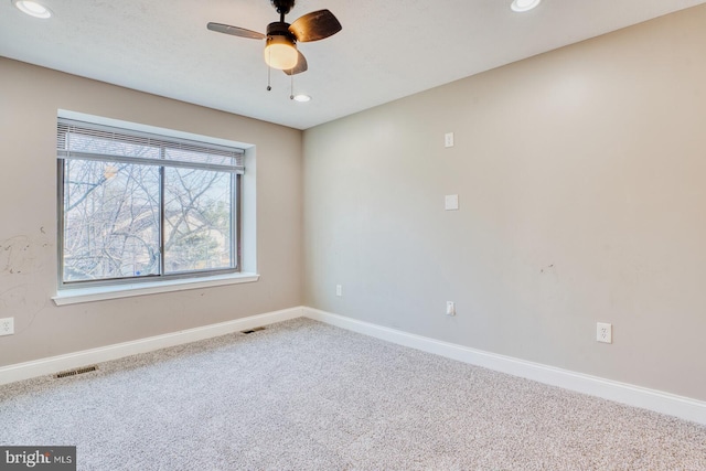 carpeted empty room featuring ceiling fan