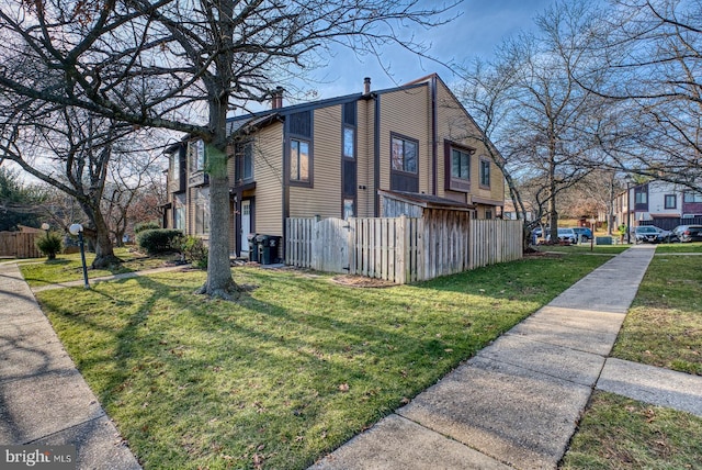 view of side of property with a lawn