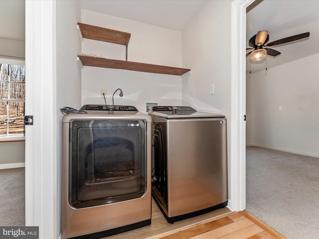 washroom featuring ceiling fan, light colored carpet, and washer and clothes dryer