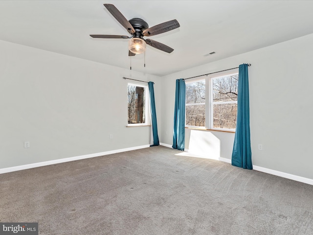 spare room with ceiling fan and carpet