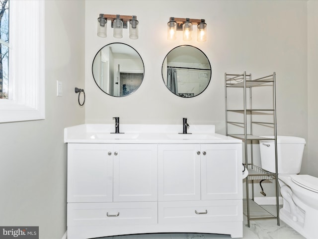 bathroom featuring vanity, walk in shower, and toilet