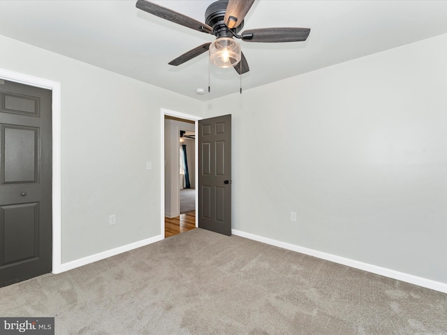 unfurnished bedroom featuring light carpet and ceiling fan