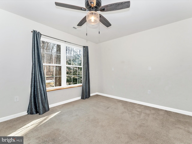 carpeted spare room featuring ceiling fan