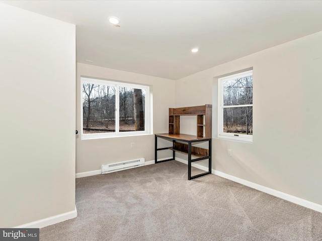 spare room featuring carpet floors and a baseboard radiator