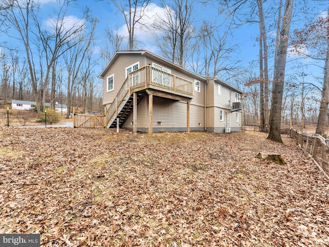 back of house with a wooden deck