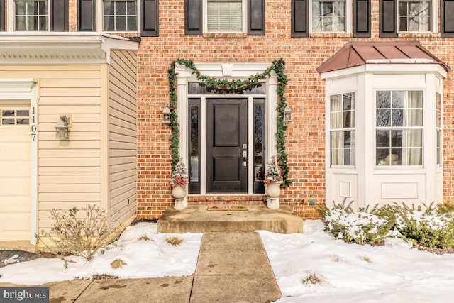 view of snow covered property entrance