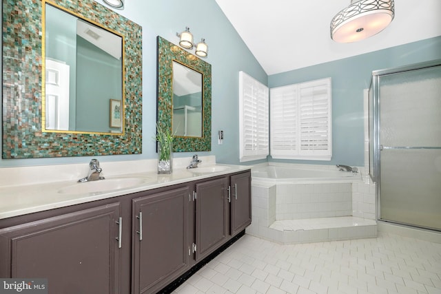 bathroom featuring vanity, vaulted ceiling, shower with separate bathtub, and tile patterned flooring