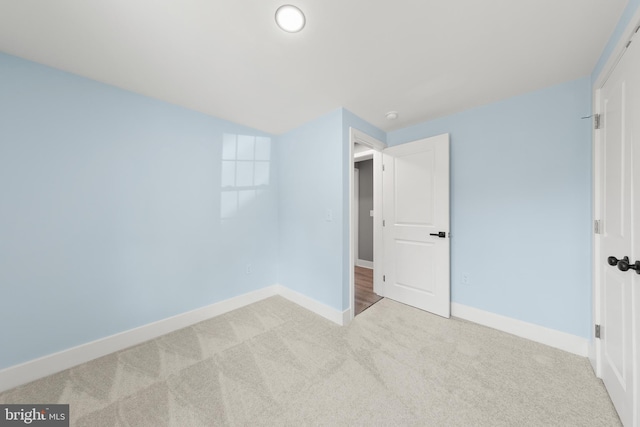 unfurnished bedroom featuring baseboards and carpet flooring