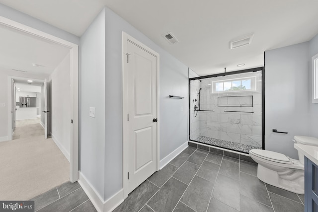 bathroom with visible vents, baseboards, toilet, and a shower stall