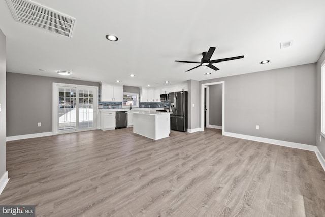 interior space with open floor plan, visible vents, and appliances with stainless steel finishes