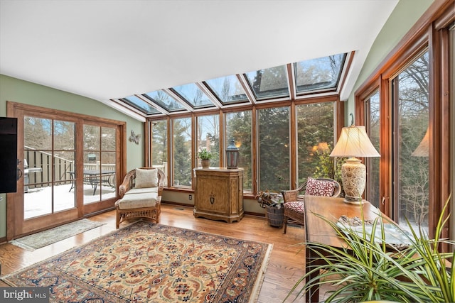 sunroom / solarium with vaulted ceiling with skylight