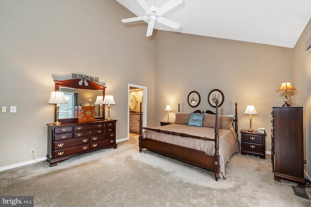 bedroom with ceiling fan, ensuite bathroom, high vaulted ceiling, and light carpet