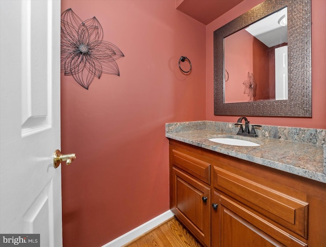 bathroom featuring hardwood / wood-style flooring and vanity