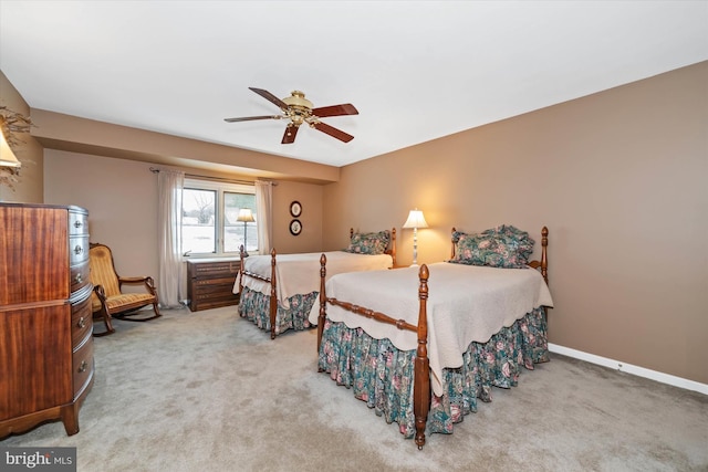 bedroom featuring ceiling fan and carpet