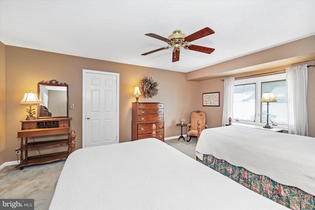 bedroom with ceiling fan and light carpet