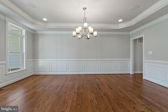 unfurnished room with a raised ceiling, crown molding, and dark hardwood / wood-style floors