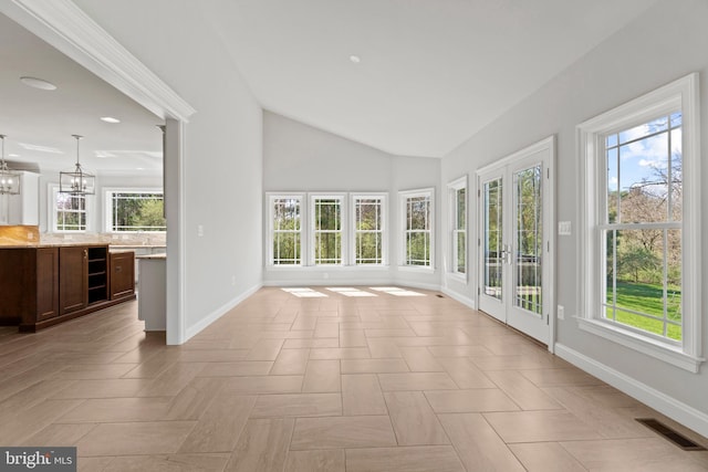 unfurnished sunroom featuring an inviting chandelier and vaulted ceiling