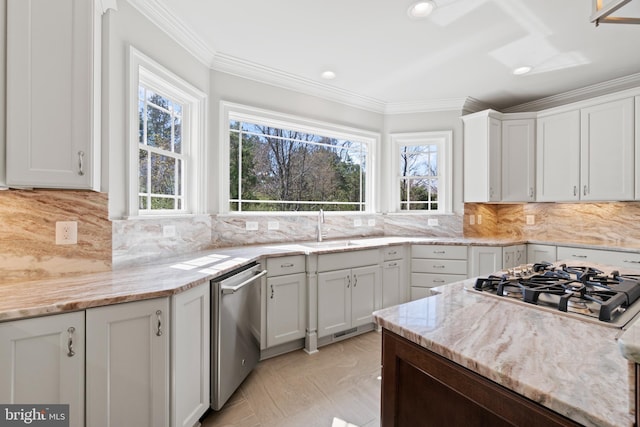 kitchen with light stone counters, white cabinets, and appliances with stainless steel finishes