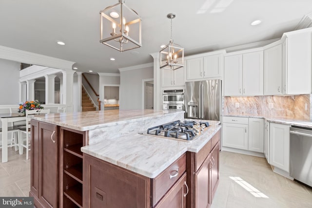 kitchen featuring white cabinetry, a center island, appliances with stainless steel finishes, and pendant lighting