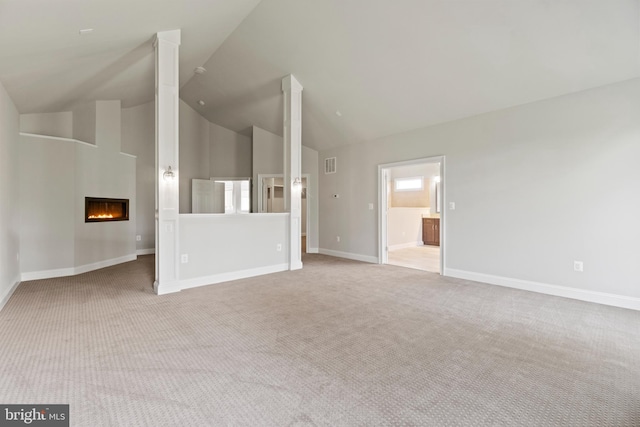 unfurnished living room featuring light colored carpet and lofted ceiling