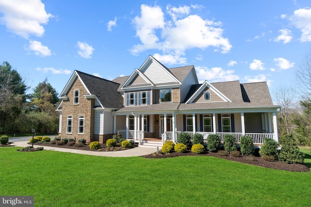 craftsman-style home featuring covered porch and a front lawn