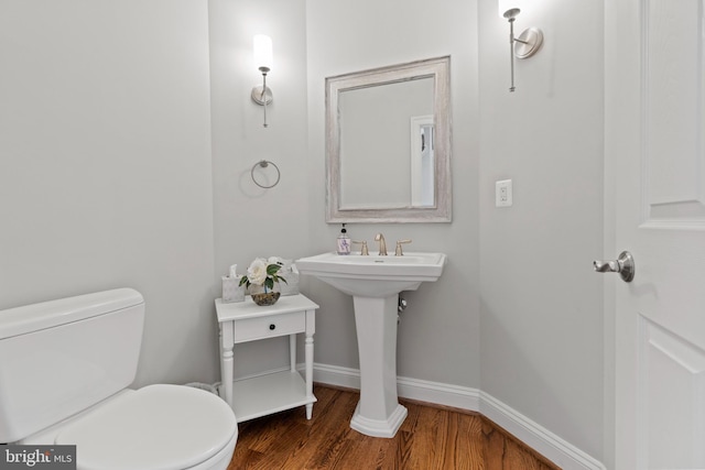 bathroom featuring hardwood / wood-style floors and toilet