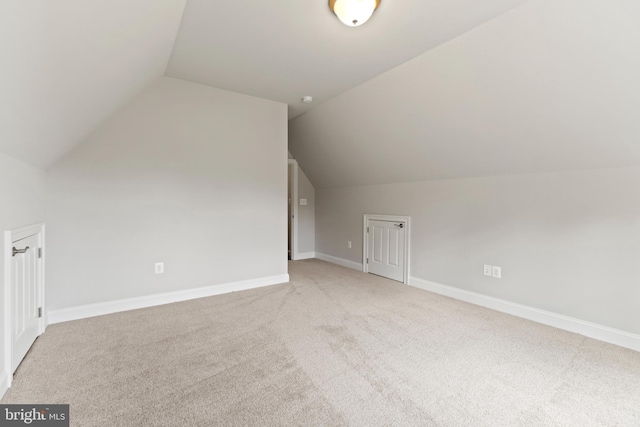 additional living space featuring carpet and lofted ceiling