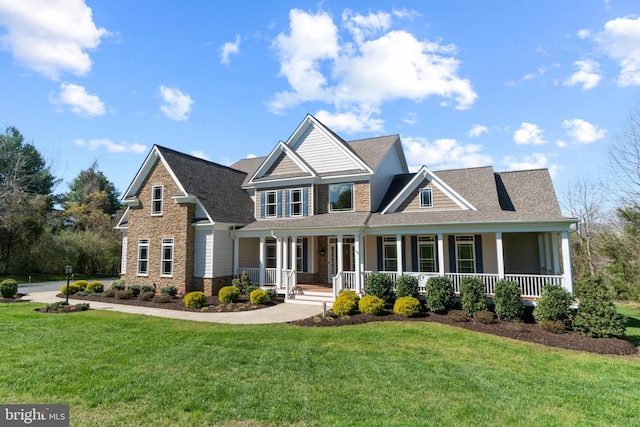 craftsman-style home featuring a porch and a front lawn